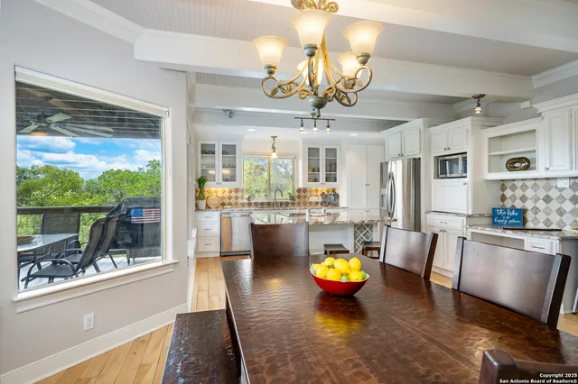 a bathroom with a granite countertop toilet sink and mirror