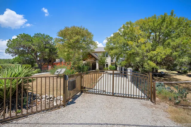 a front view of a house with garden and plants