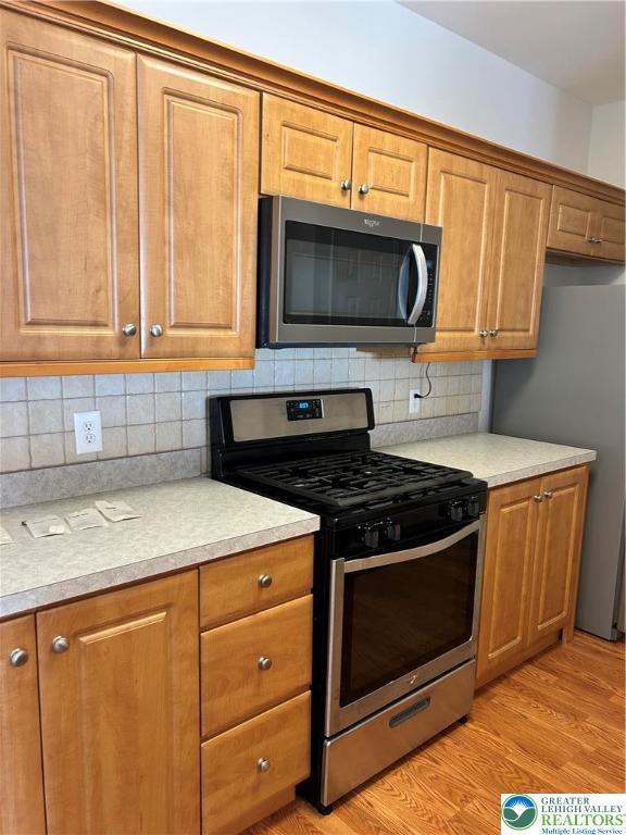 1113 Old Course Lane Easton, PA 18042 - Photo 5 of 26 a kitchen with stainless steel appliances granite countertop a sink stove and microwave