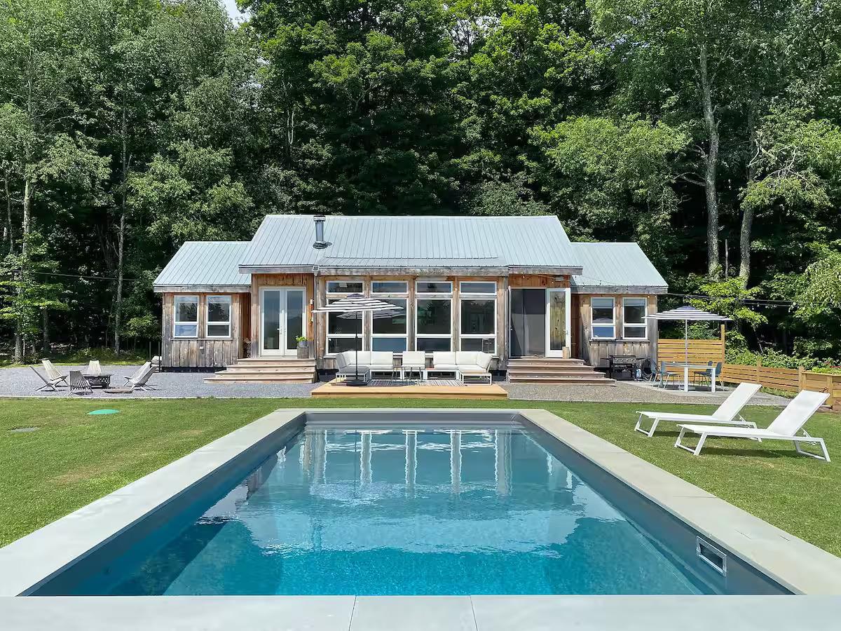 31 Big Rock Road Halcottsville, NY 12438 - Photo 1 of 1 Front of property with a lawn, an outdoor pool, a patio area, an outdoor living space with a fire pit, and entry steps