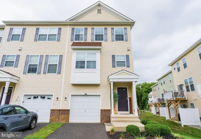 a front view of a residential apartment building with a yard
