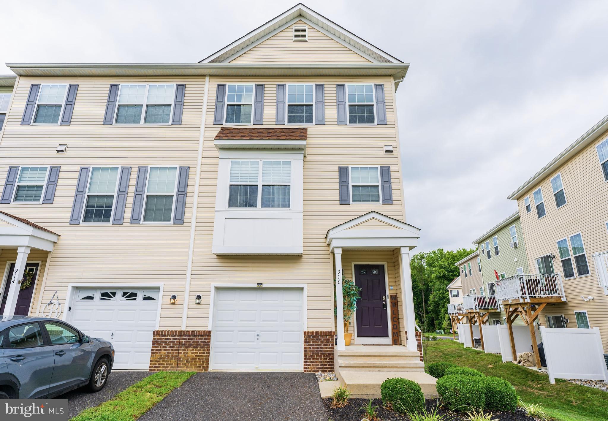 a front view of a residential apartment building with a yard