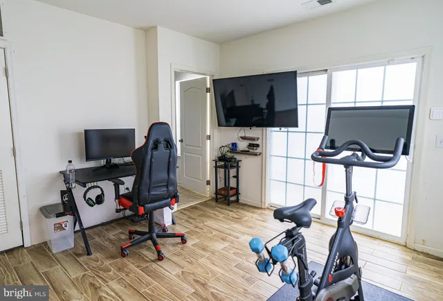 a view of a workspace with furniture and a window