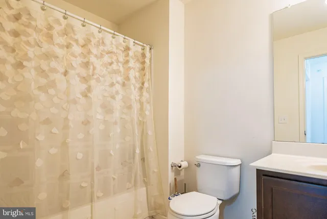 a white toilet sitting next to a white sink