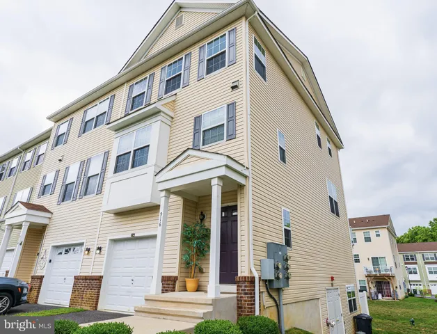 a front view of a building with a yard