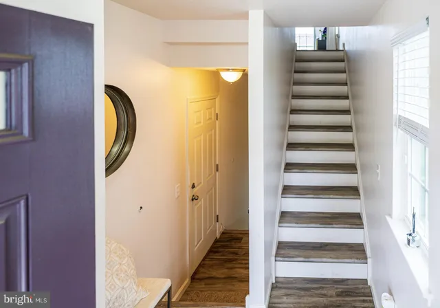 a view of a hallway with wooden walls and windows