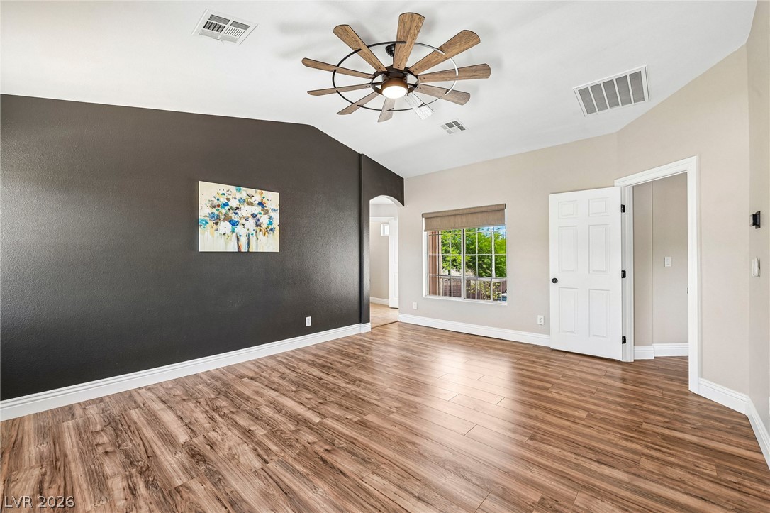 1176 Butternut Ranch Court Henderson, NV 89052 - Photo 33 of 60 Natural light pours into this spacious room featuring stylish wood flooring and a distinctive ceiling fan.