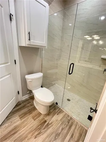 a bathroom with a toilet and a shower
