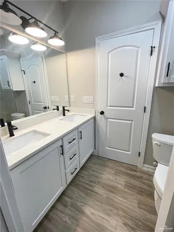 a spacious bathroom with a double vanity sink and a mirror