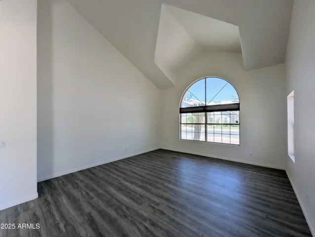 an empty room with windows and entrance