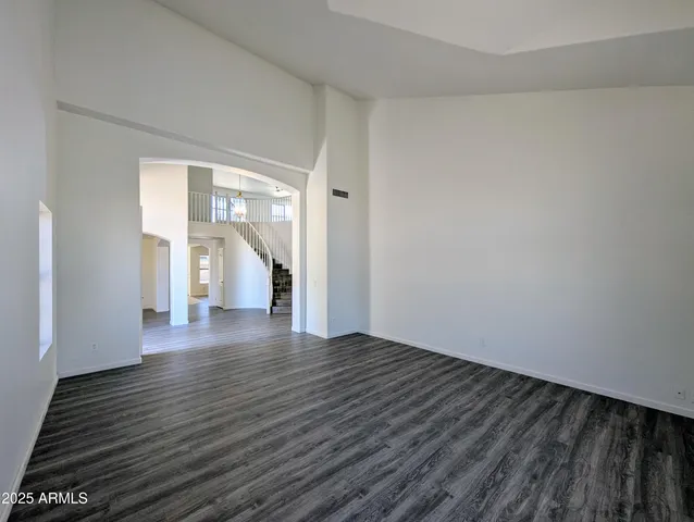 a view of empty room with wooden floor and fireplace