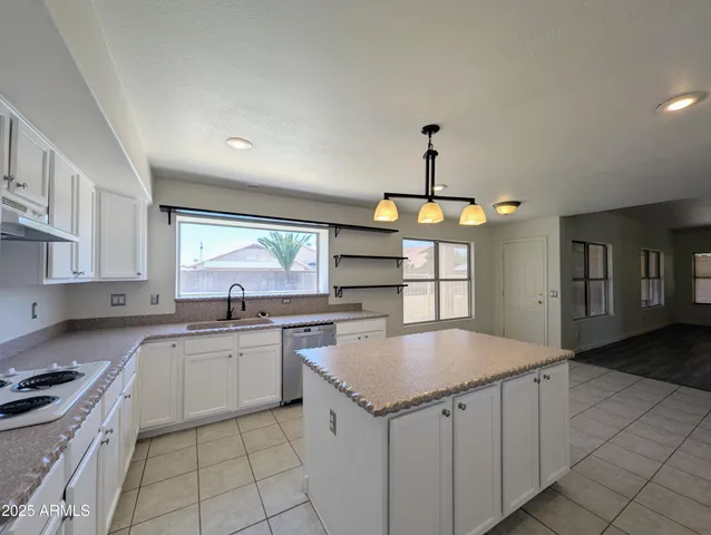a view of a kitchen with wooden floor and windows