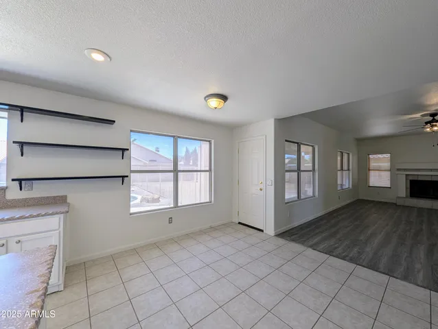 a view of a hallway with wooden floor and stairs