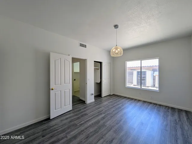 a view of a room with wooden floor and a window