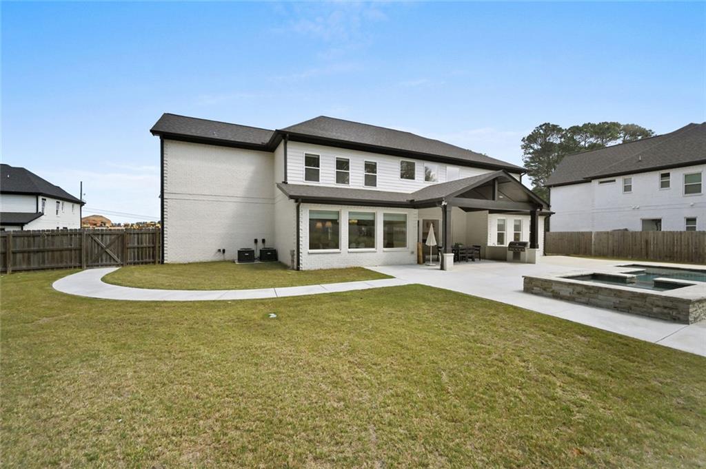 2694 Thompson Mill Road Buford, GA 30519 - Photo 67 of 70 a view of a house with swimming pool and a yard
