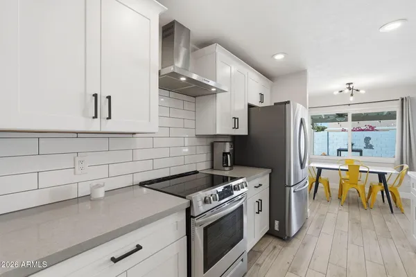a kitchen with stainless steel appliances granite countertop a stove and a refrigerator