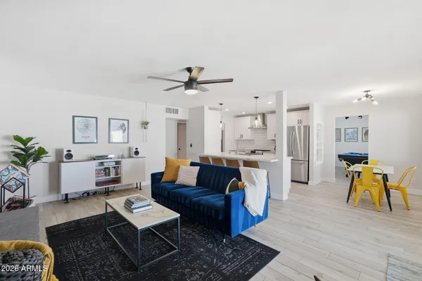 a living room with furniture ceiling fan and a fireplace