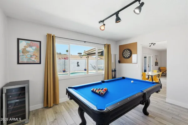 a living room with furniture kitchen view and a chandelier