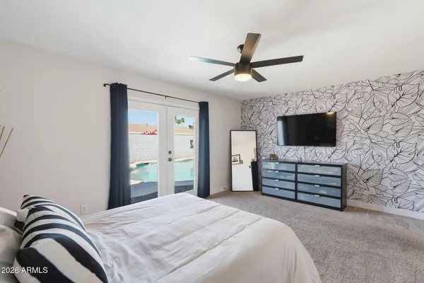 a bedroom with a bed and a painting on the wall