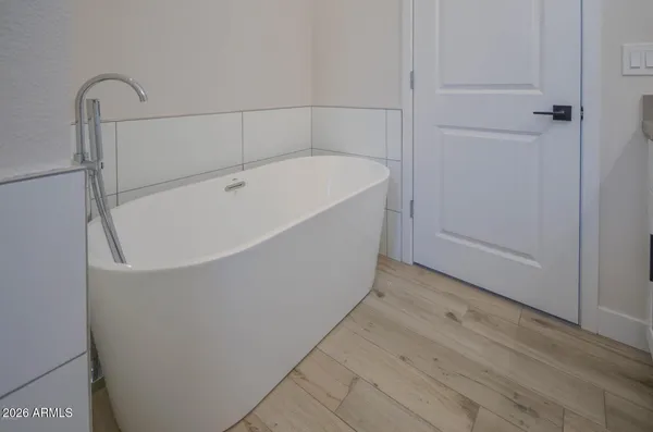 a bathroom with a bathtub and shower