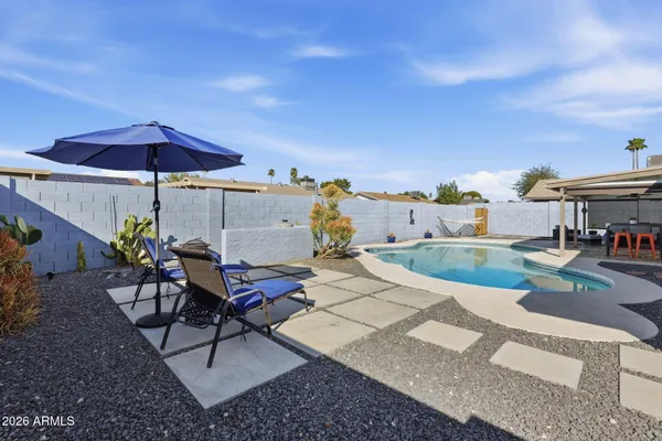 a view of house with backyard outdoor seating and wooden floor
