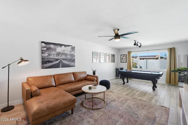 a view of a hallway with wooden floor and entryway