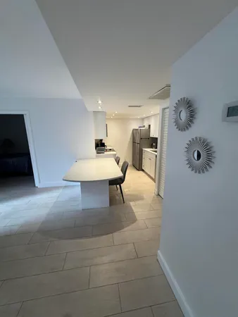 a living room with a table and chairs