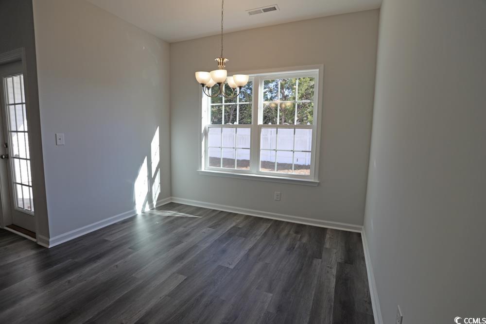 Spare room featuring dark hardwood / wood-style fl