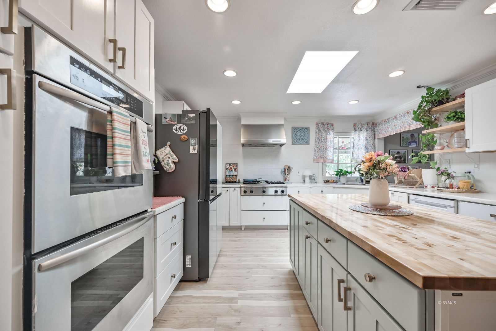 1025 Randall Street Ridgecrest, CA 93555 - Photo 6 of 50 a kitchen with stainless steel appliances granite countertop a lot of counter space and wooden floors