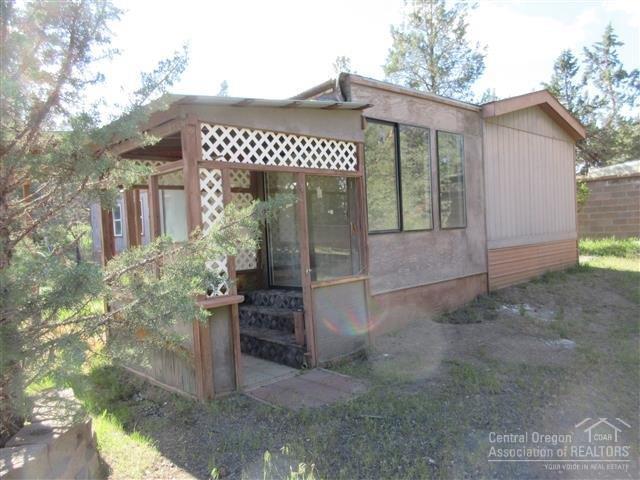 8883 Southwest Sand Ridge Road Terrebonne, OR 97760 - Photo 12 of 17 Covered area with sliding glass door lea