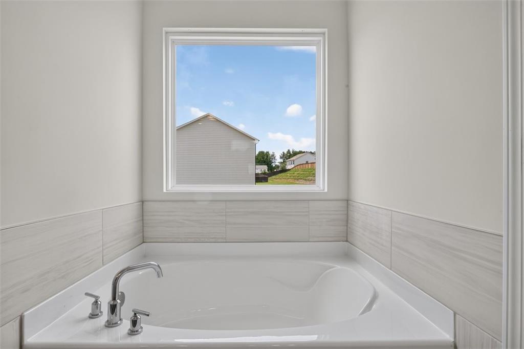 107 Ledgemont Way Acworth, GA 30101 - Photo 37 of 57 a close up of a bathtub in a bathroom