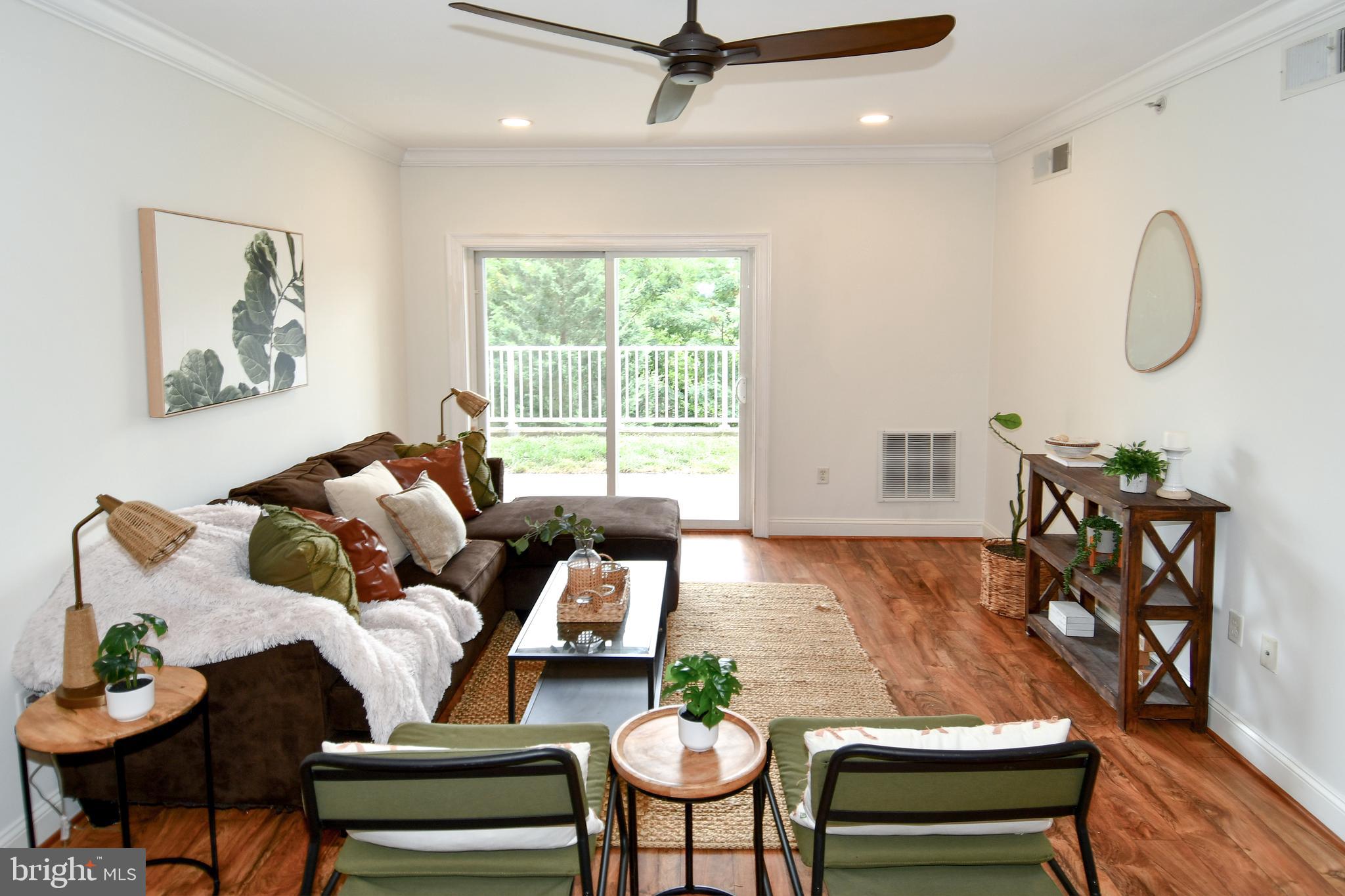 6301 Edsall Road, Unit 115 Alexandria, VA 22312 - Photo 11 of 37 a living room with furniture a table and a large window