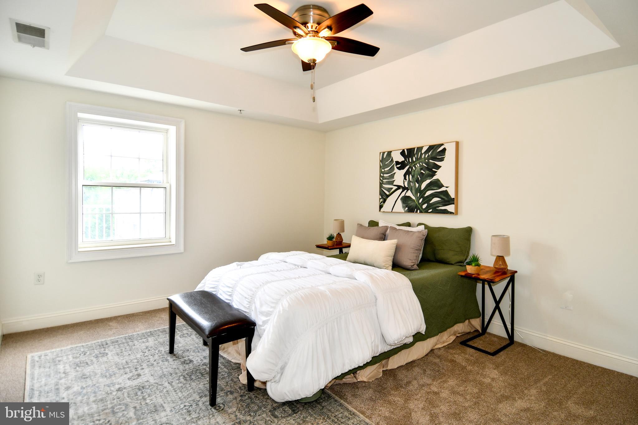 6301 Edsall Road, Unit 115 Alexandria, VA 22312 - Photo 13 of 37 a bedroom with a bed and a chandelier