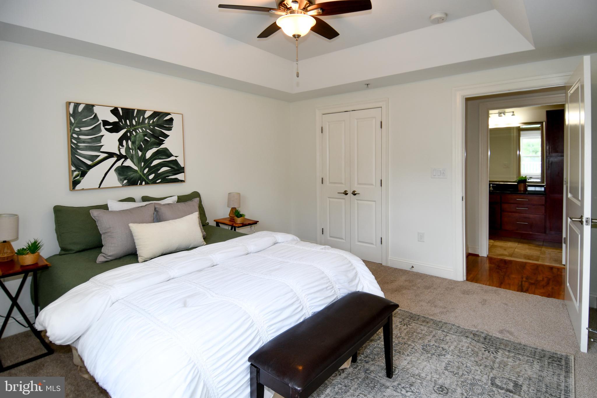 6301 Edsall Road, Unit 115 Alexandria, VA 22312 - Photo 14 of 37 a bedroom with a bed and a chandelier