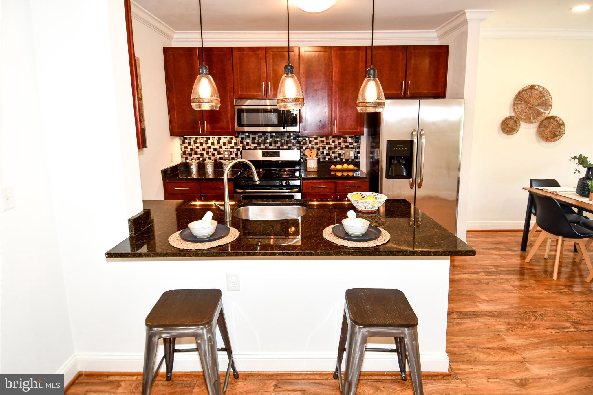 6301 Edsall Road, Unit 115 Alexandria, VA 22312 - Photo 2 of 37 a kitchen with a table and chairs
