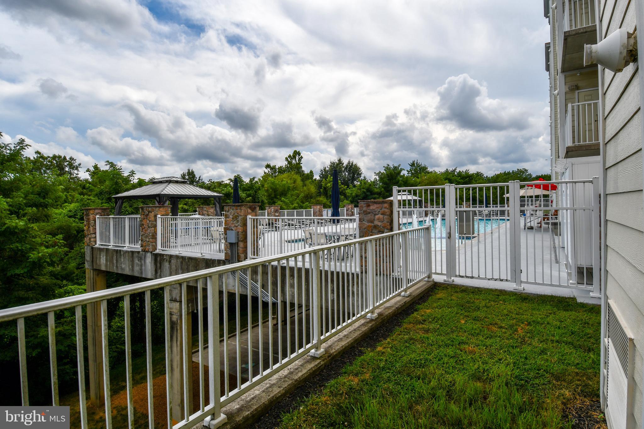 6301 Edsall Road, Unit 115 Alexandria, VA 22312 - Photo 24 of 37 a view of a deck with a big yard and wooden fence
