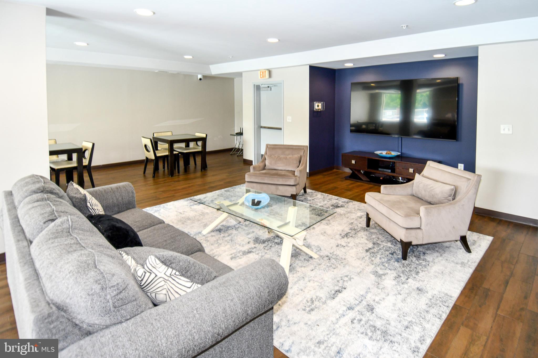 6301 Edsall Road, Unit 115 Alexandria, VA 22312 - Photo 32 of 37 a living room with furniture and a flat screen tv