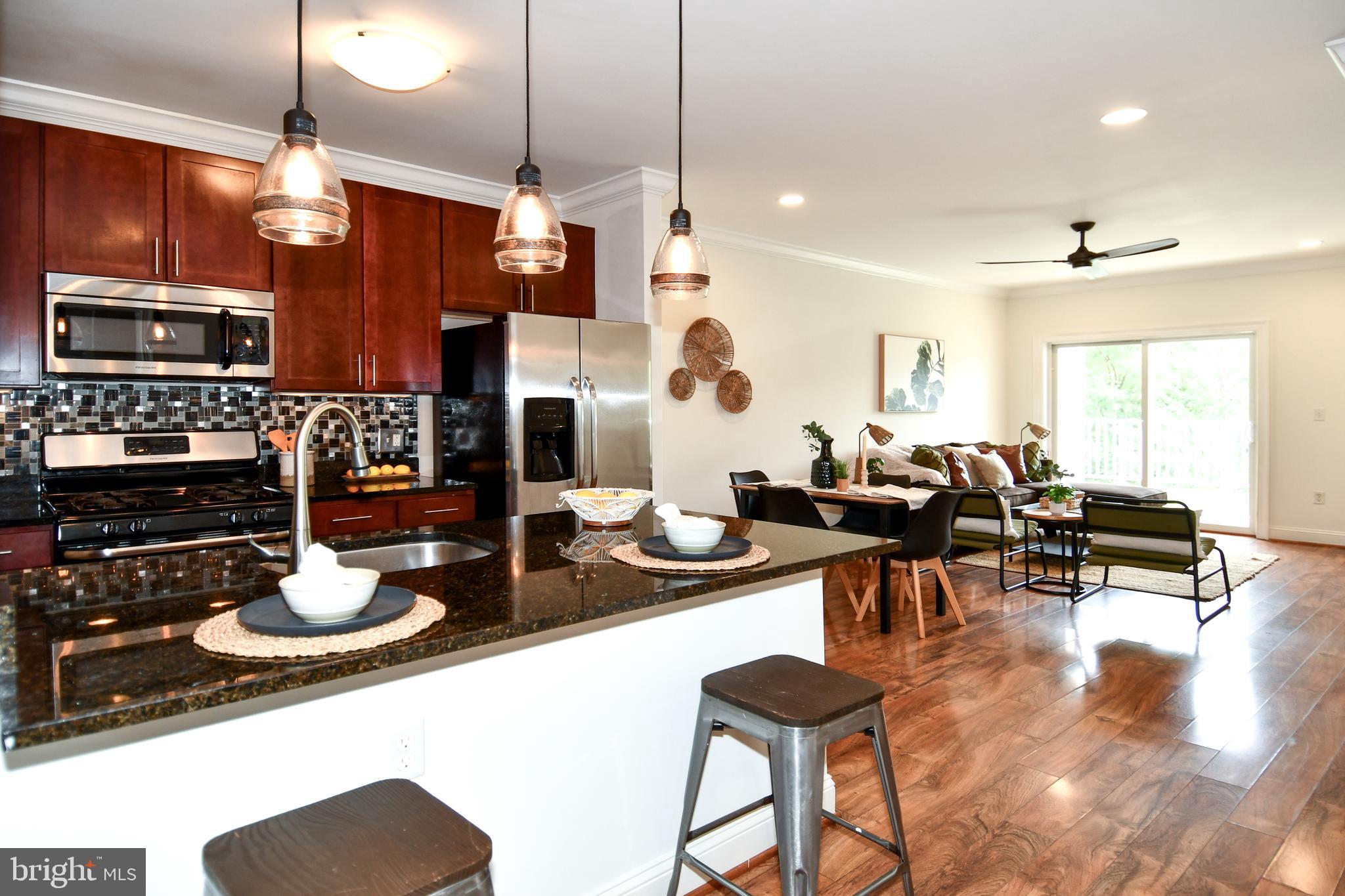 6301 Edsall Road, Unit 115 Alexandria, VA 22312 - Photo 6 of 37 a kitchen with sink refrigerator and dining room