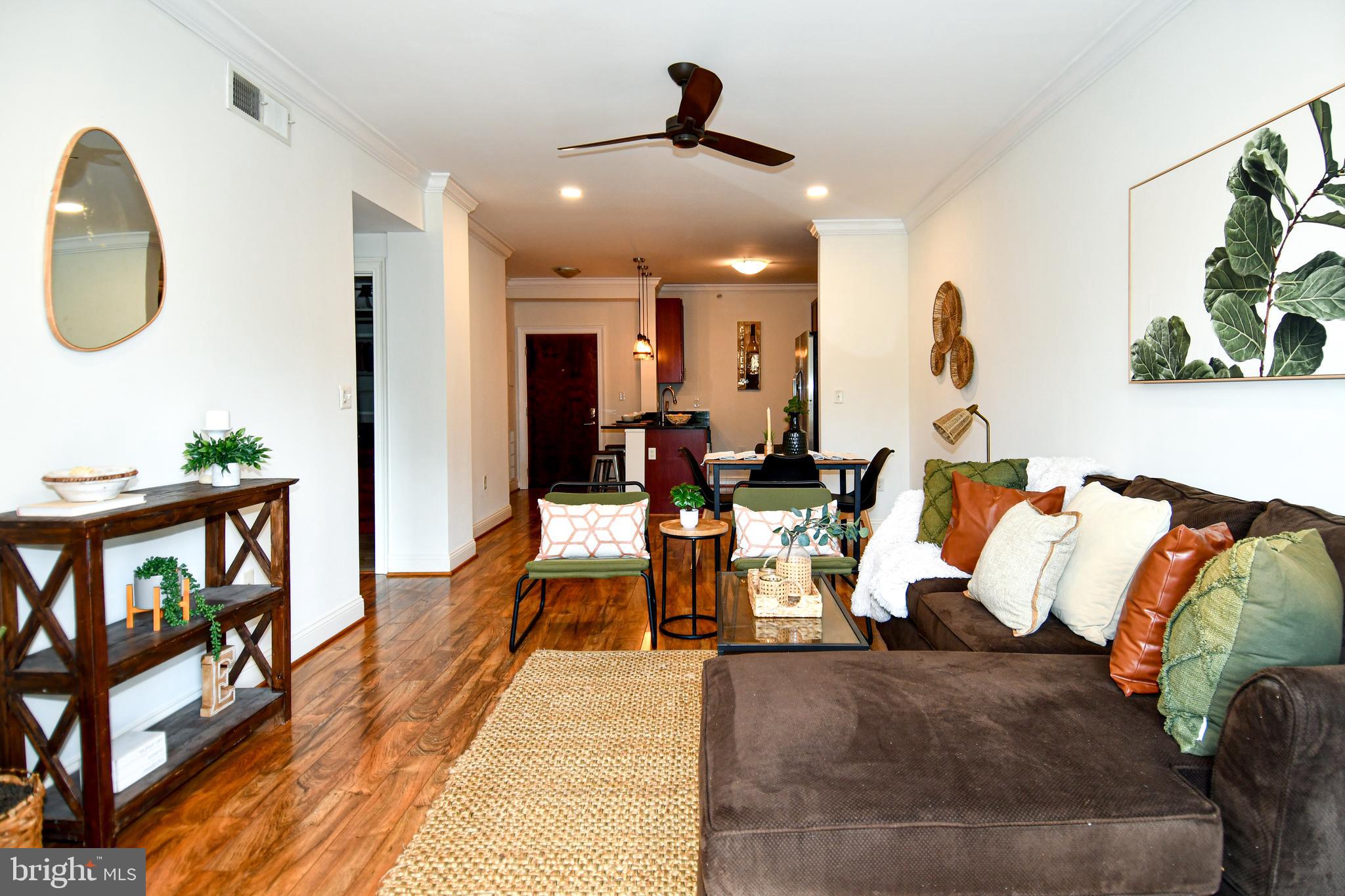 6301 Edsall Road, Unit 115 Alexandria, VA 22312 - Photo 9 of 37 a living room with furniture kitchen view and a wooden floor