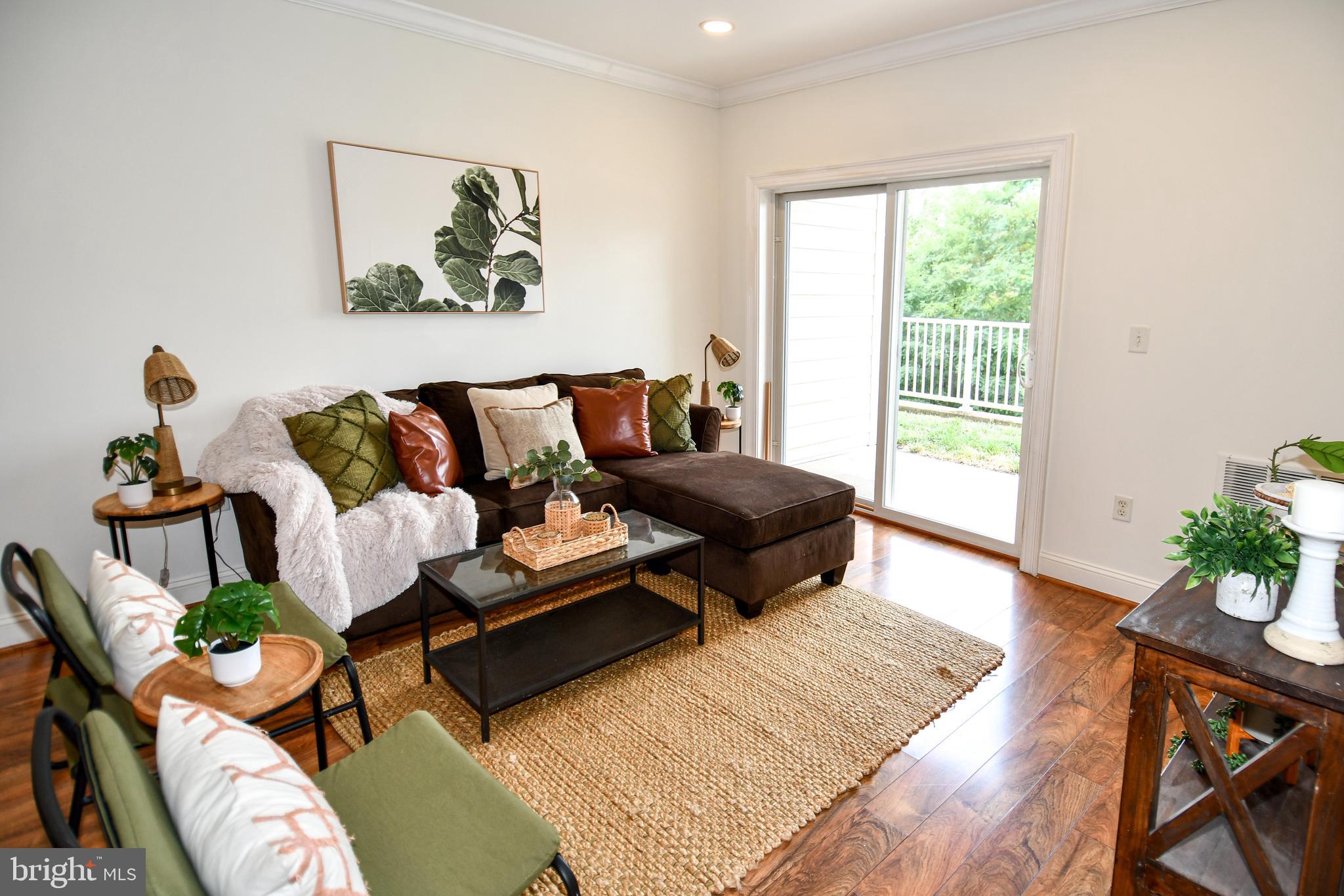 6301 Edsall Road, Unit 115 Alexandria, VA 22312 - Photo 10 of 37 a living room with furniture and a potted plant
