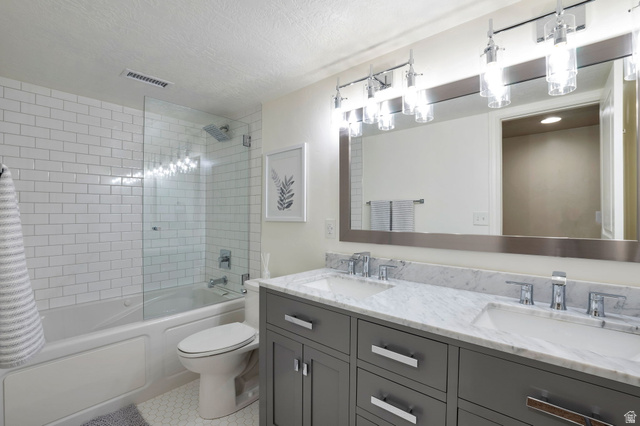 577 South Ridge Top Lane East North Salt Lake, UT 84054 - Photo 34 of 57 Spacious bathroom featuring a dual vanity and beautifully tiled tub/shower combination.