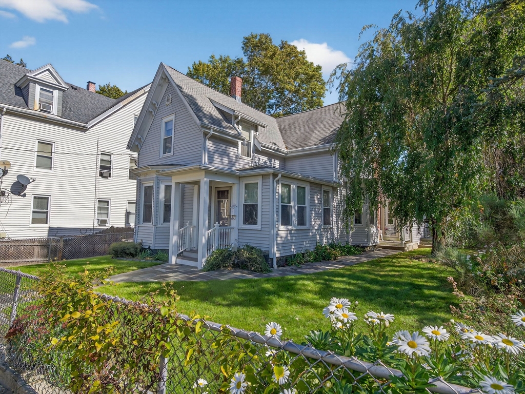 148 Beaver Street Boston, MA 02136 - Photo 1 of 25 a view of a house with a big yard potted plants and large tree