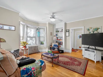 a living room with furniture and a large window