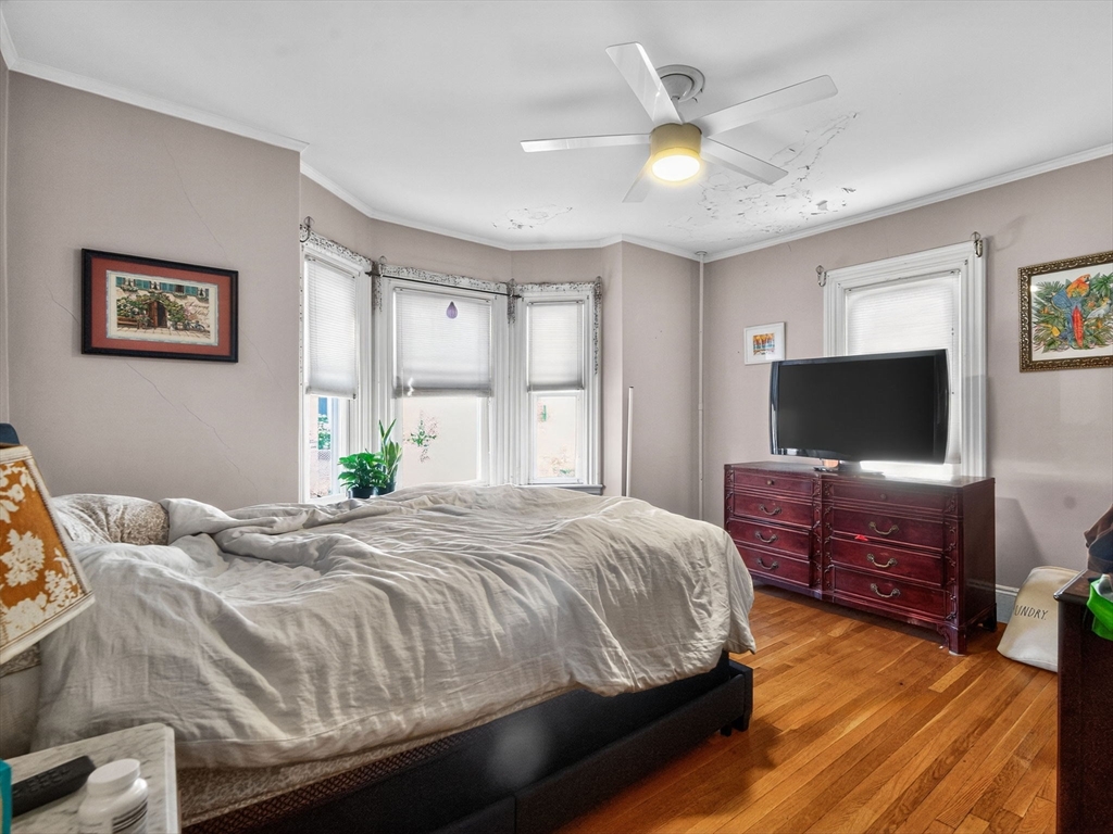 148 Beaver Street Boston, MA 02136 - Photo 15 of 25 a bedroom with a bed and a flat screen tv