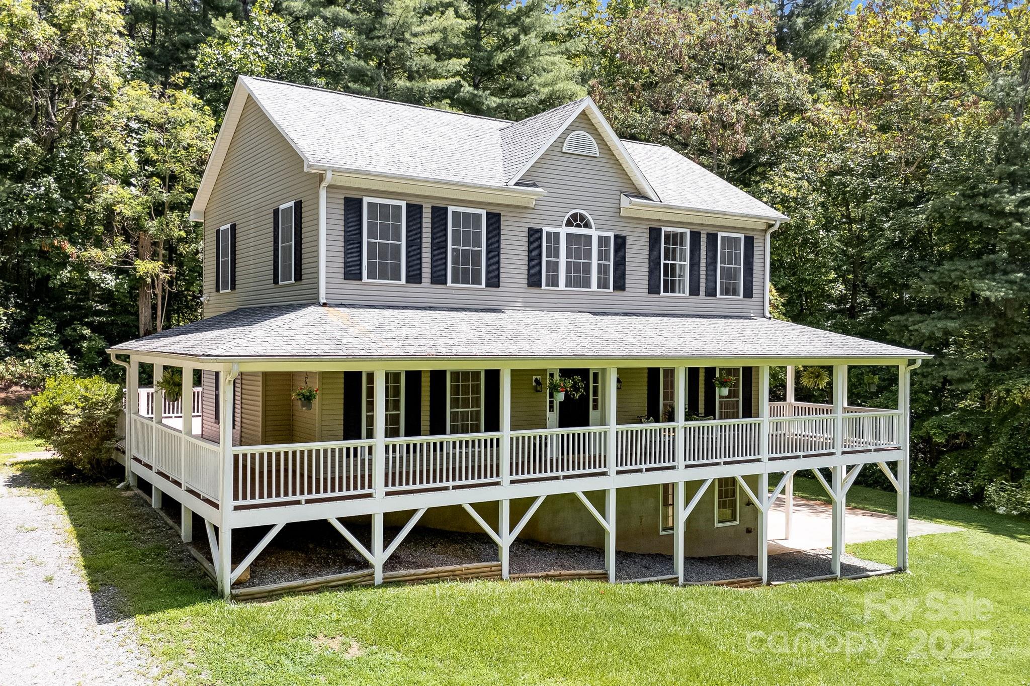a front view of a house with a yard and deck