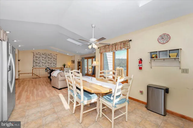 a view of a dining room with furniture and chandelier