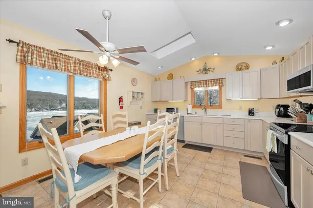a kitchen with a table chairs stove and cabinets