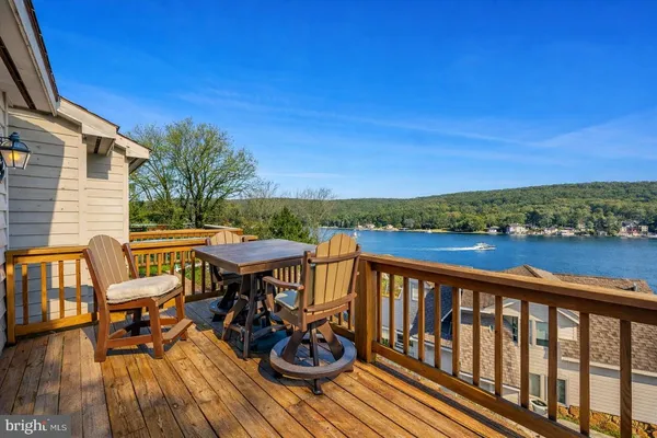 a view of a chairs and table on the deck
