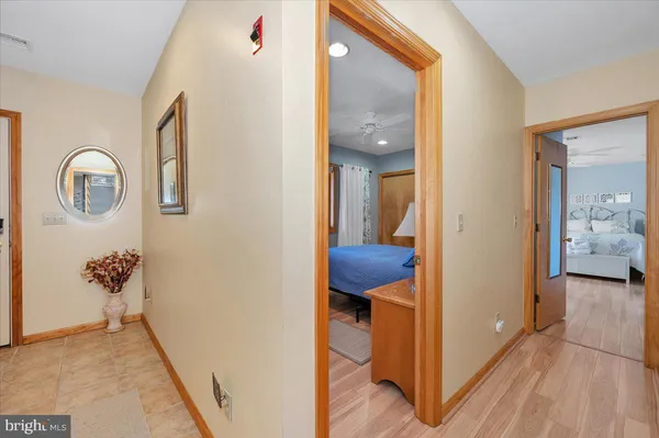 a view of a hallway with a room and wooden floor