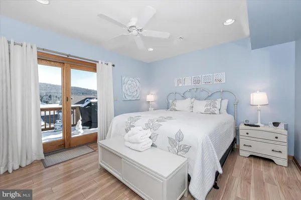 a bedroom with a large bed and a window